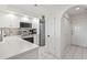 Bright white kitchen with stainless steel appliances, white cabinets, and tiled flooring at 4405 Eastport Blvd. # D-8, Little River, SC 29566