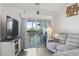 Bright living room with a sliding glass door to a private balcony and comfortable reclining sofa at 4405 Eastport Blvd. # D-8, Little River, SC 29566