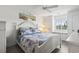 Serene main bedroom featuring a cozy quilt, bedside table, and natural light from the outdoor view at 4405 Eastport Blvd. # D-8, Little River, SC 29566