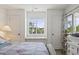 Inviting main bedroom showcasing a cozy quilt, window seat, and plenty of closet space at 4405 Eastport Blvd. # D-8, Little River, SC 29566