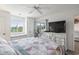 Comfortable main bedroom with a cozy quilt, window seat, and access to a relaxing screened porch at 4405 Eastport Blvd. # D-8, Little River, SC 29566