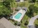 Aerial view of a beautiful pool with lounge chairs, surrounded by lush landscaping at 4405 Eastport Blvd. # D-8, Little River, SC 29566