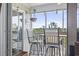 Charming screened-in porch with stylish bar stools and peaceful views of the surrounding natural beauty at 4405 Eastport Blvd. # D-8, Little River, SC 29566