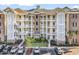 Charming condominium with a combination of light yellow and brown brick, complemented by a well-manicured lawn and convenient parking at 4861 Luster Leaf Circle # 204, Myrtle Beach, SC 29577