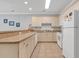 Bright kitchen with white appliances, neutral tile flooring, and abundant cabinet space offering a functional cooking environment at 4861 Luster Leaf Circle # 204, Myrtle Beach, SC 29577