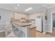 Well-lit kitchen featuring a breakfast bar with seating, a full appliance suite, and ample cabinet storage space at 4861 Luster Leaf Circle # 204, Myrtle Beach, SC 29577