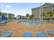 Outdoor pool surrounded by lounge chairs and lush landscaping in a condo community at 4861 Luster Leaf Circle # 204, Myrtle Beach, SC 29577