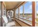 Enclosed balcony with seating and view of a lush fairway and tranquil lake at 501 Maison Dr. # E20, Myrtle Beach, SC 29572