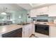 Open kitchen with breakfast bar providing views to the living area and backyard at 501 Maison Dr. # E20, Myrtle Beach, SC 29572