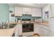 Bright kitchen with white cabinets, laminate countertops, and a full suite of appliances at 501 Maison Dr. # E20, Myrtle Beach, SC 29572