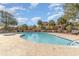 Outdoor swimming pool surrounded by palm trees and landscaping, providing a tropical oasis at 501 Maison Dr. # E20, Myrtle Beach, SC 29572