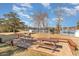 Charming picnic area with wooden tables on a brick patio, set against a serene lake backdrop and blue skies at 501 Maison Dr. # E20, Myrtle Beach, SC 29572