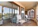 Enclosed porch with sliding glass doors and seating provides views of the outdoor landscape at 501 Maison Dr. # E20, Myrtle Beach, SC 29572