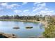 Picturesque water view showcasing the serene lake and lush green golf course in the background under blue skies at 501 Maison Dr. # E20, Myrtle Beach, SC 29572