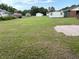 Expansive backyard with a large grassy area, storage sheds, and a quaint patio perfect for outdoor activities at 506 Byrnes Circle, Johnsonville, SC 29555