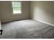 Neutral carpeted bedroom featuring a large window for plenty of natural light at 506 Byrnes Circle, Johnsonville, SC 29555
