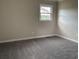Simple carpeted bedroom with a single window, and a neutral color scheme at 506 Byrnes Circle, Johnsonville, SC 29555