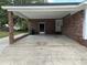 Spacious carport featuring a brick support column and access doors, perfect for vehicle storage at 506 Byrnes Circle, Johnsonville, SC 29555
