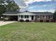 Charming one-story brick home with a well-maintained lawn and a covered parking area at 506 Byrnes Circle, Johnsonville, SC 29555