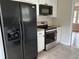 Kitchen with black appliances, including a refrigerator, stove, and microwave at 506 Byrnes Circle, Johnsonville, SC 29555
