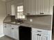 Bright kitchen with updated white cabinets and black hardware, plus a stone-style backsplash at 506 Byrnes Circle, Johnsonville, SC 29555