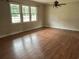 Bright and airy living room with hardwood flooring, a ceiling fan, and large windows offering ample light at 506 Byrnes Circle, Johnsonville, SC 29555