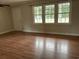 Living room with hardwood floors, bright windows, and a ceiling fan at 506 Byrnes Circle, Johnsonville, SC 29555