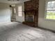 Cozy living room featuring a brick fireplace, neutral carpet, and bright natural light at 506 Byrnes Circle, Johnsonville, SC 29555