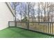 Back deck has green turf and a railing with views of a wooded backyard at 4350 Spa Dr. # 506, Little River, SC 29566