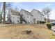 Exterior view of a two-story residential building with gray siding and stairs leading to the upper units at 4350 Spa Dr. # 506, Little River, SC 29566