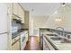 Open-concept kitchen featuring white appliances, mosaic backsplash, and a sink overlooking the home's backyard at 4350 Spa Dr. # 506, Little River, SC 29566