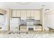 A well-equipped kitchen featuring stylish countertops, white appliances, and a convenient washer/dryer setup at 4350 Spa Dr. # 506, Little River, SC 29566