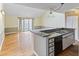 Open-concept room featuring laminate floors, sliding glass doors, and a kitchen area at 4350 Spa Dr. # 506, Little River, SC 29566