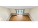 Well-lit living room boasts wood floors and sliding glass door to the outside at 4350 Spa Dr. # 506, Little River, SC 29566