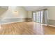 Living room with laminate floors, neutral walls, and sliding glass doors at 4350 Spa Dr. # 506, Little River, SC 29566