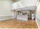Bright living room featuring hardwood floors, a kitchen bar, and high ceilings that create an open, airy atmosphere at 4350 Spa Dr. # 506, Little River, SC 29566