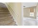 Carpeted stairs leading to an upstairs bedroom with a cozy window and soft natural light at 4350 Spa Dr. # 506, Little River, SC 29566