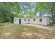 The rear of the house shows a spacious yard with mature trees providing ample shade at 512 W Baptist St., Marion, SC 29571