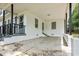 An outdoor living space with a covered back porch and gray railing, for relaxation at 512 W Baptist St., Marion, SC 29571