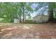 A large backyard featuring sheds and mature trees providing ample shade at 512 W Baptist St., Marion, SC 29571