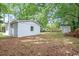 A large backyard featuring sheds and mature trees providing ample shade at 512 W Baptist St., Marion, SC 29571
