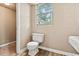 Bathroom with toilet, sink and wood-look floors at 512 W Baptist St., Marion, SC 29571