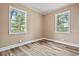 Bedroom showcasing two windows, neutral walls, and modern flooring at 512 W Baptist St., Marion, SC 29571