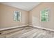 Bedroom showcasing two windows, neutral walls, and wood-look flooring at 512 W Baptist St., Marion, SC 29571
