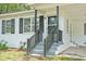 Welcoming front porch with gray stairs and a black railing, offering a cozy entrance at 512 W Baptist St., Marion, SC 29571