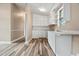 Charming kitchen features white cabinetry, a sink, and wood-look flooring at 512 W Baptist St., Marion, SC 29571