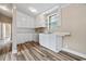 Charming kitchen features white cabinetry, a sink, and wood-look flooring at 512 W Baptist St., Marion, SC 29571