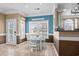 Dining area with natural light, white table and chairs, open to kitchen at 6001 - 8022 S Kings Hwy., Myrtle Beach, SC 29575