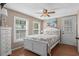 Inviting bedroom with light-colored walls, two bright windows, and a ceiling fan at 6001 - N84 S Kings Hwy., Myrtle Beach, SC 29575