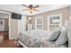 Bright bedroom with a ceiling fan, television, light wood floors, and a large bed at 6001 - N84 S Kings Hwy., Myrtle Beach, SC 29575